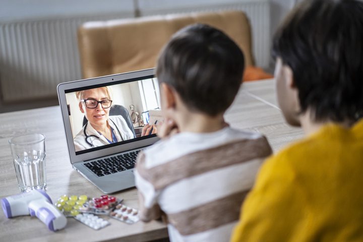 Mother with her son having video call with a doctor from home Mother with her son having video call with a doctor from home