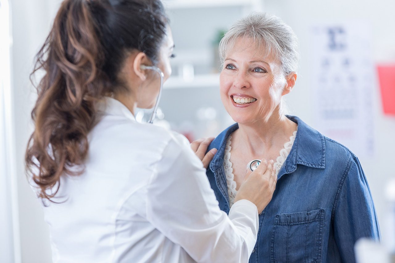 Woman checking woman's heart Woman checking woman's heart